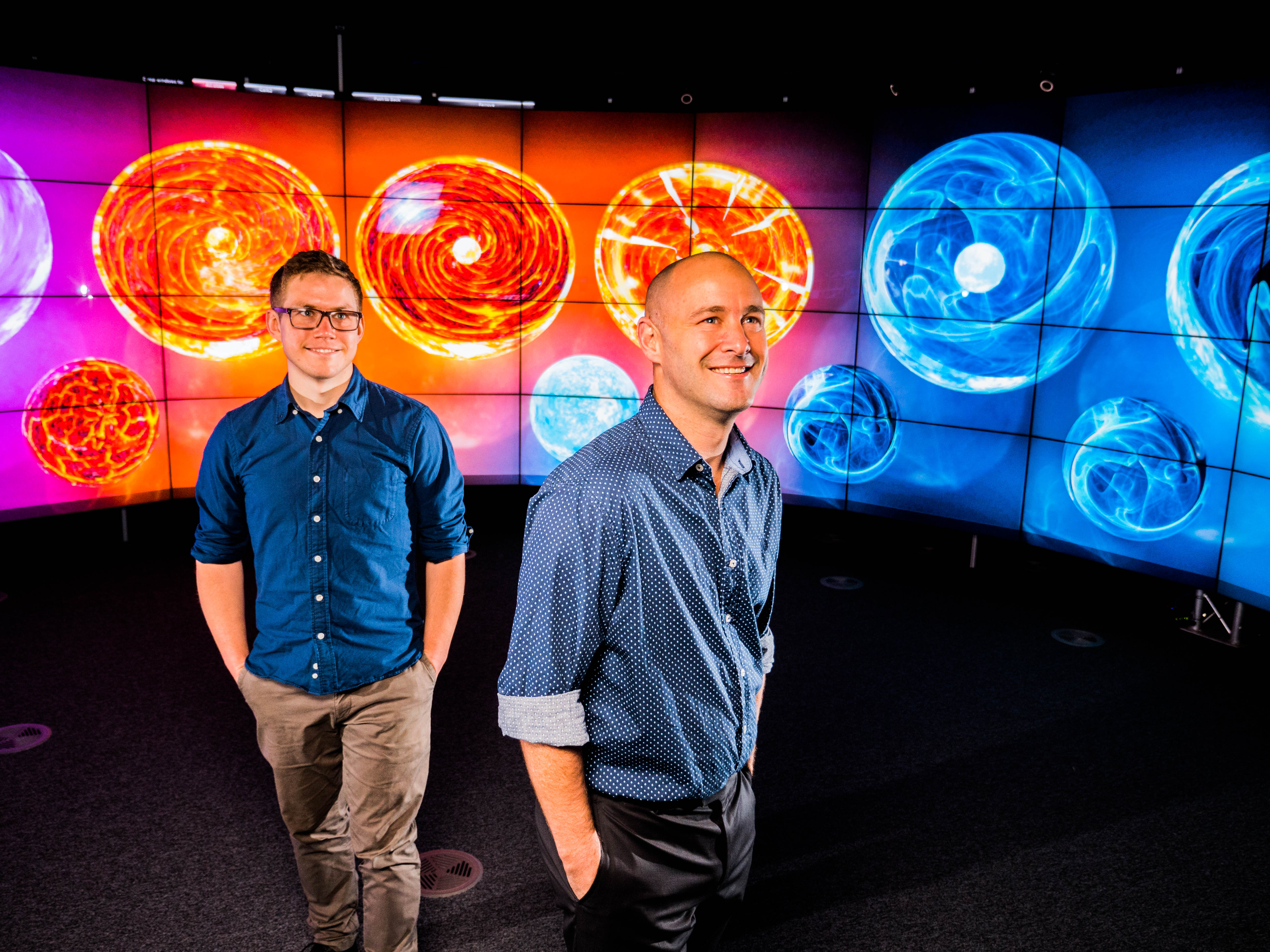 Greg Ashton and I standing in front of neutron stars!  Images by Carl Knox.