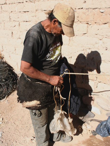man threading leather